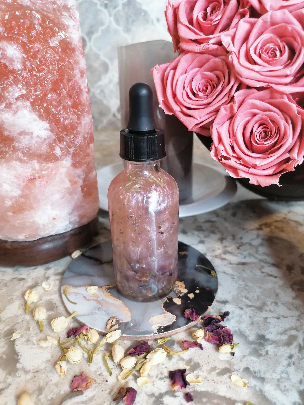 Rose ritual oil with jasmine buds and petals
