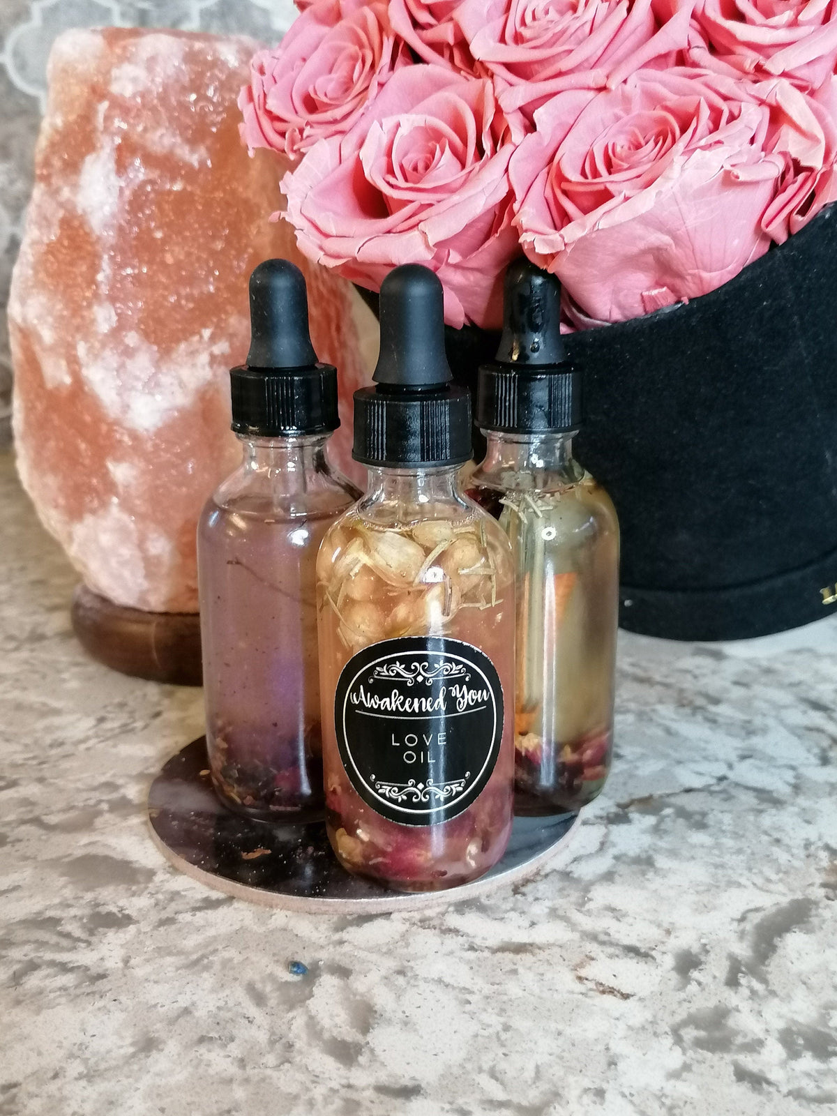 Three love oils beneath pink roses